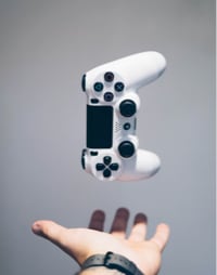 A hand throwing a game controller in the air